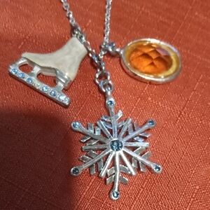 Silver Tone Pendant Necklace Featuring an Ice Skate, Snowflake And Yellow Stone
